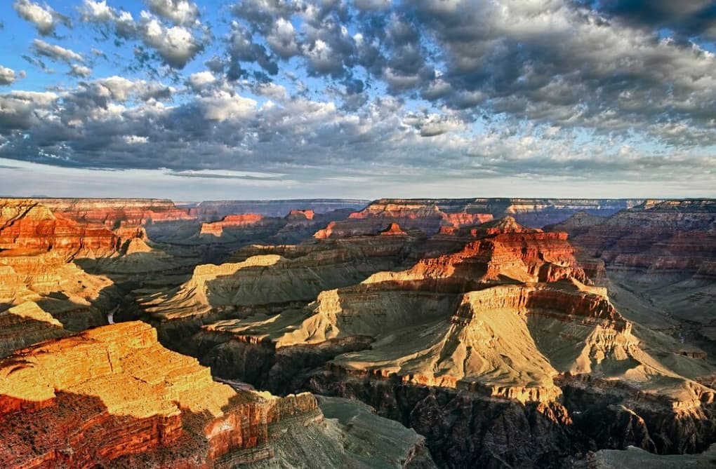 Striking clouds over the sunlit expanses of the Grand Canyon